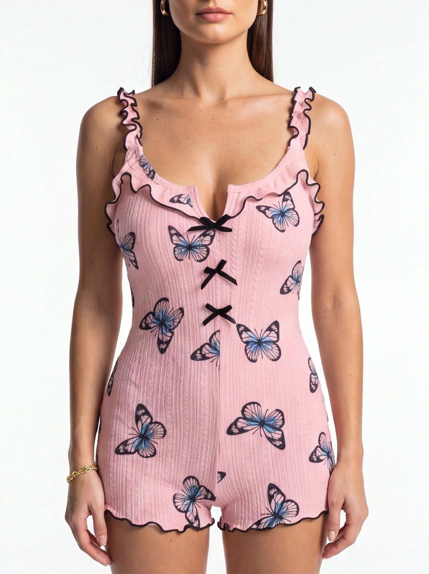 Jamota pink women's sleepwear onesie with butterfly print, ruffled straps, black trim, and front bow accents.
