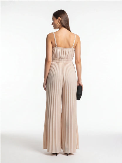 Jamota beige jumpsuit with adjustable straps, smocked waist and pleated wide-leg pants, back view.