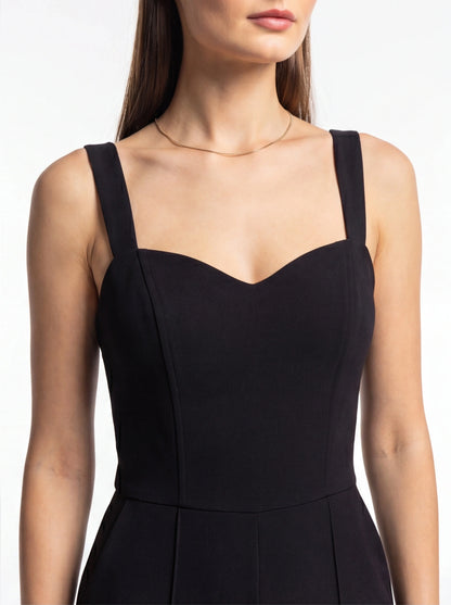 Jamota black women's jumpsuit with tailored fit, wide straps and sweetheart neckline.