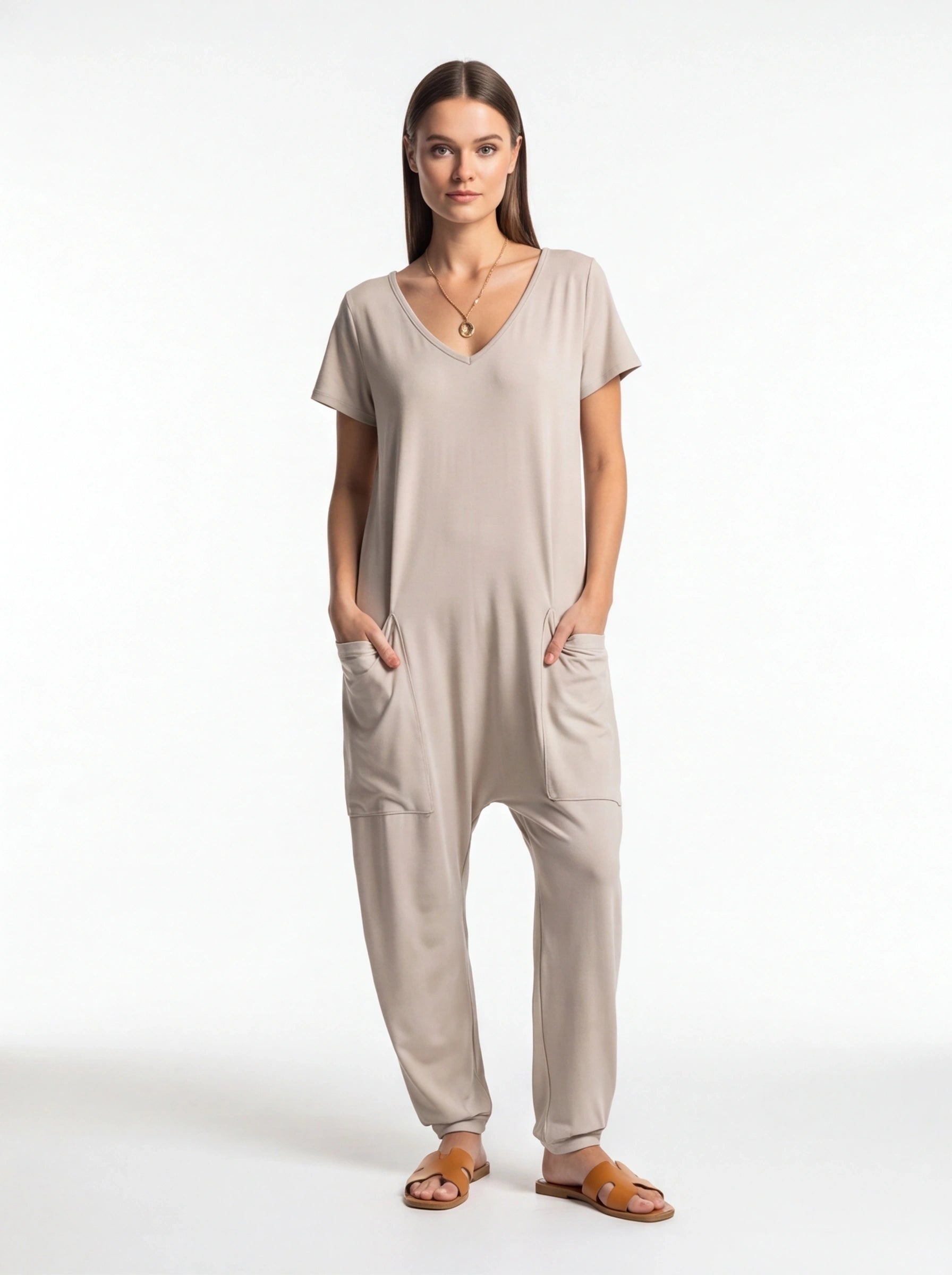 Jamota beige jumpsuit with short sleeves and side pockets; relaxed one-piece with a V-neck