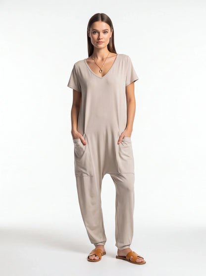 Jamota beige jumpsuit with short sleeves and side pockets; relaxed one-piece with a V-neck
