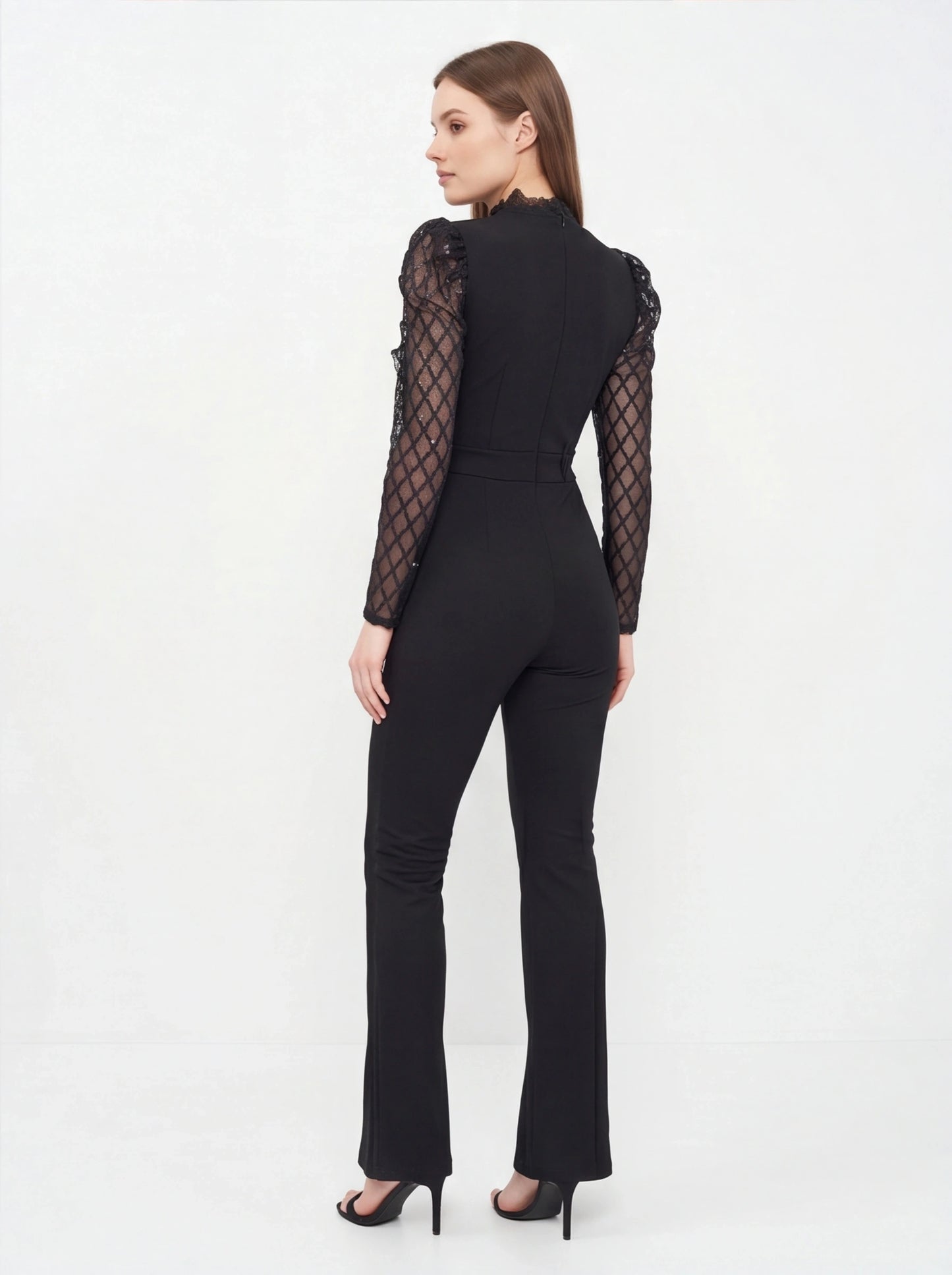 Jamota black jumpsuit with see-through lattice sleeves, lace-trim high neckline, fitted waist and flared legs.
