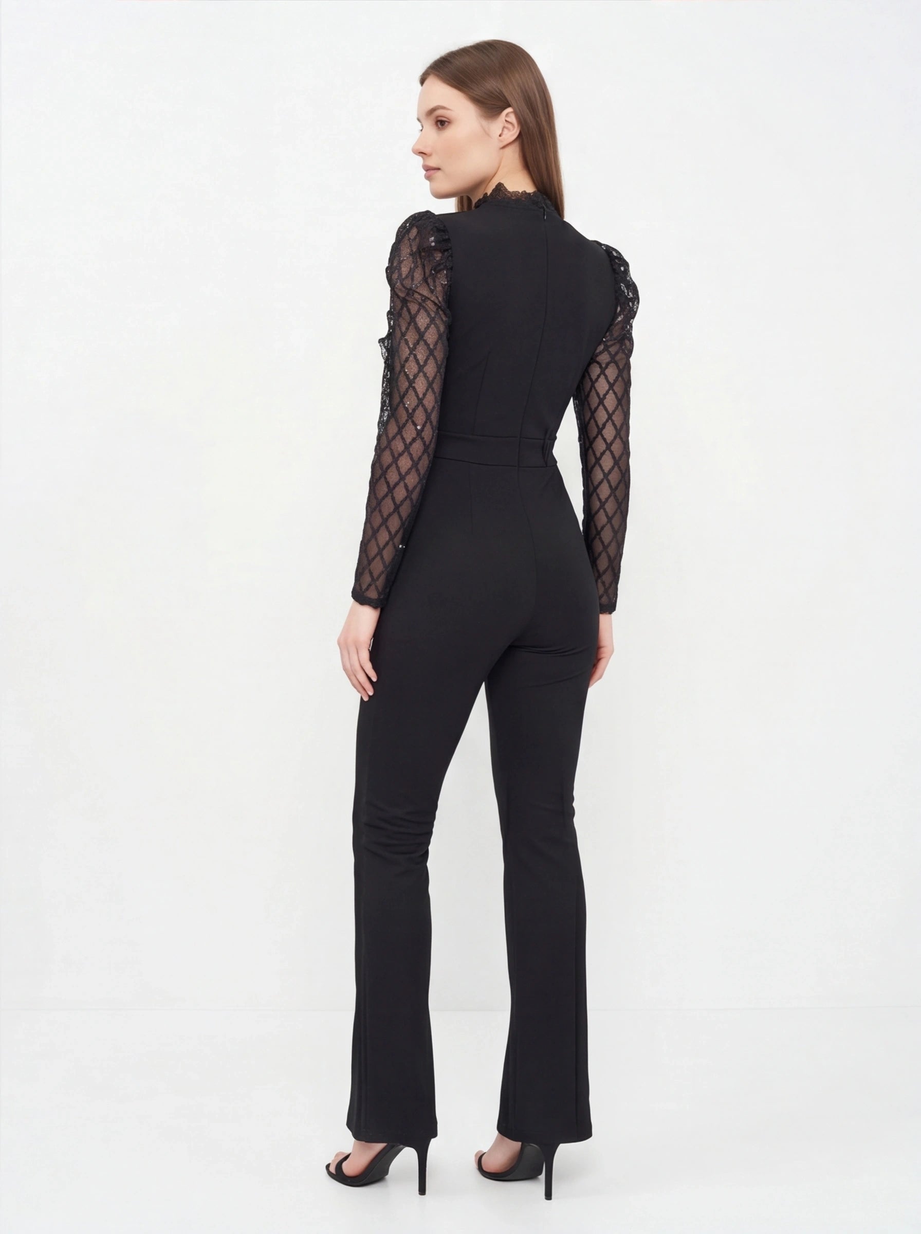 Jamota black jumpsuit with see-through lattice sleeves, lace-trim high neckline, fitted waist and flared legs.