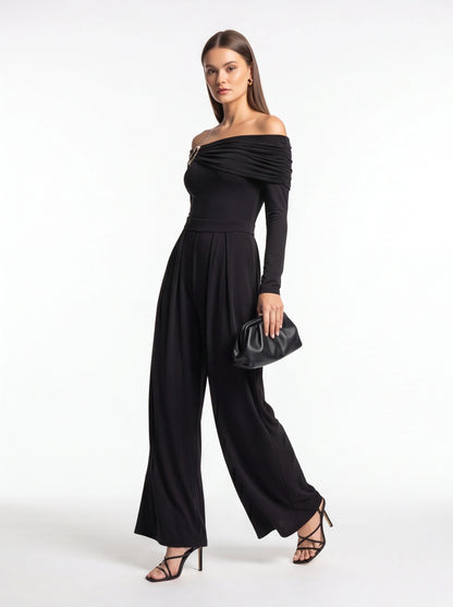 Jamota black jumpsuit with off-shoulder draped neckline, long sleeves, belt at waist and wide-leg pants