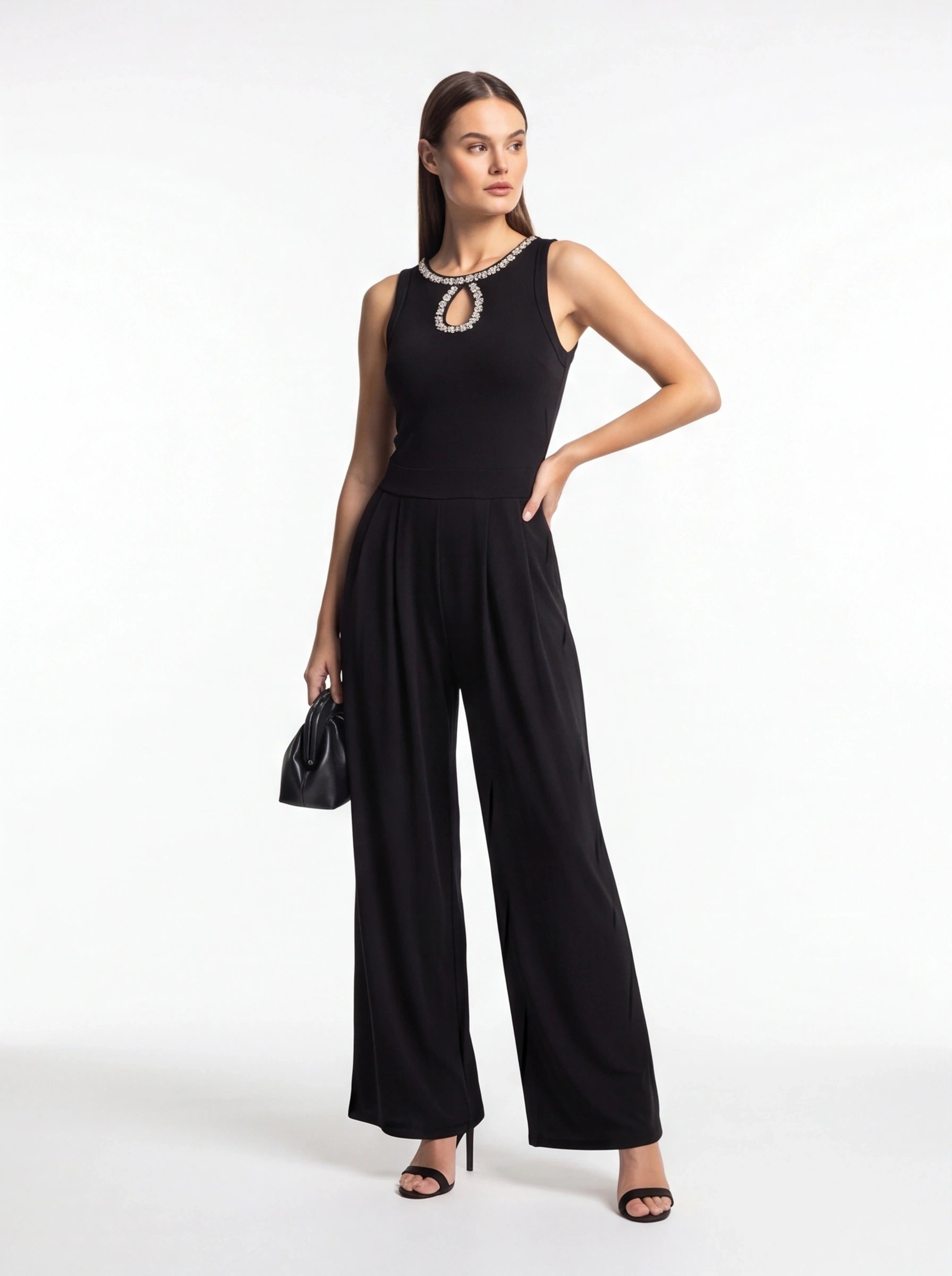 Jamota black jumpsuit with pleated wide-leg pants, sleeveless design and crystal-embellished neckline.