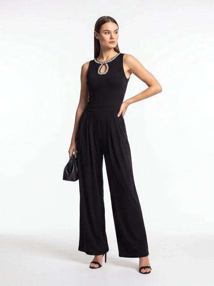 Jamota black jumpsuit with pleated wide-leg pants, sleeveless design and crystal-embellished neckline.