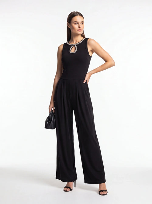 Jamota black jumpsuit with pleated wide-leg pants, sleeveless design and crystal-embellished neckline.